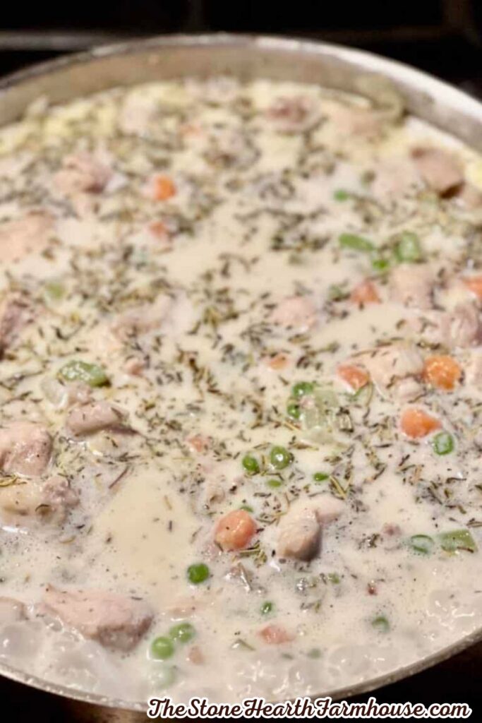 Homemade creamy pot pie filling with tender rabbit meat, peas, carrots, celery, and herbs