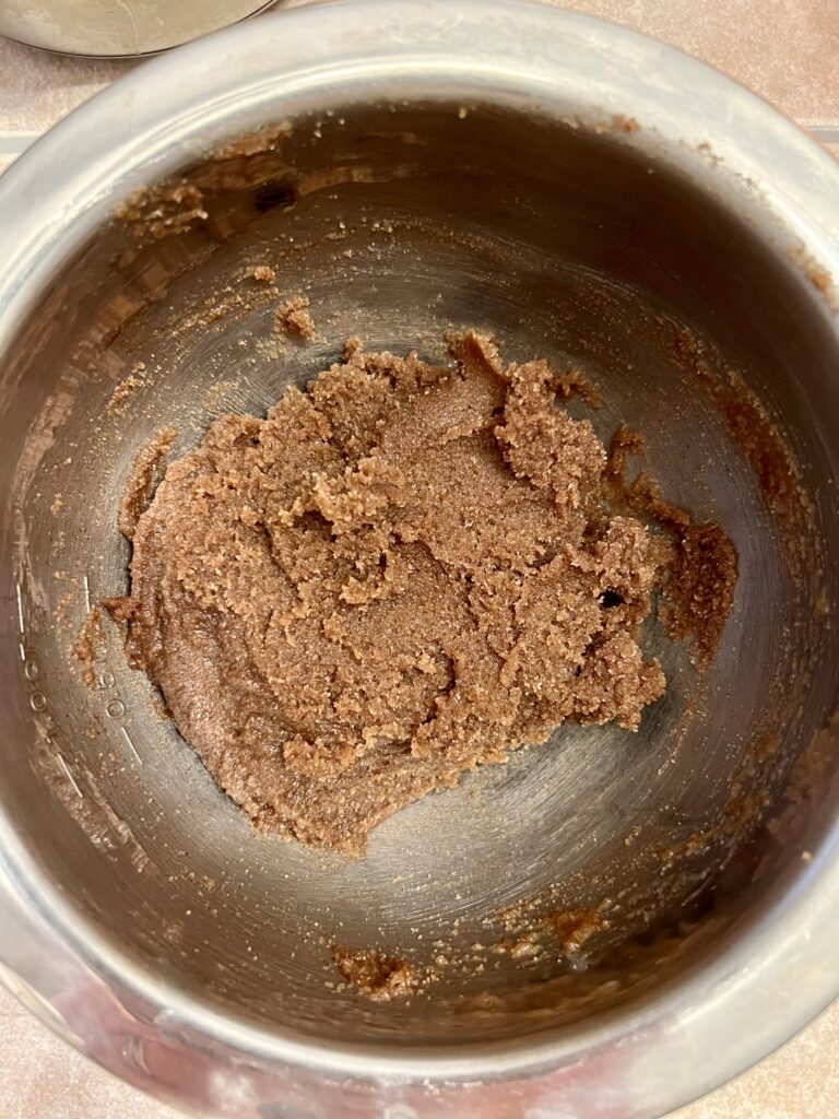 Brown sugar and cinnamon filling mixed in a metal bowl for homemade sourdough cinnamon rolls.