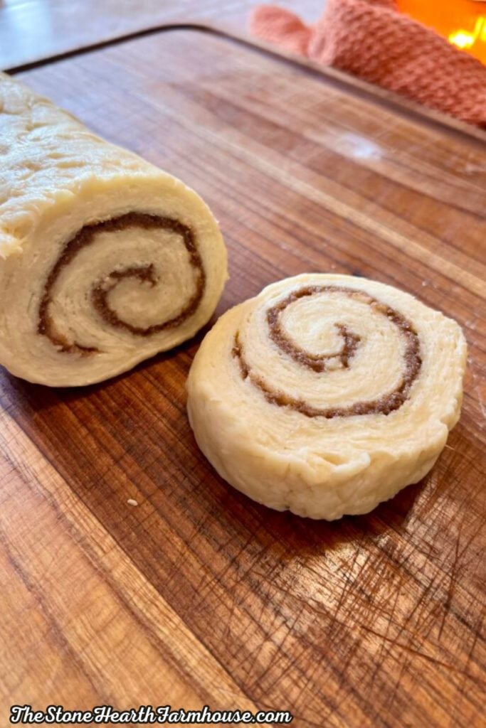 Sliced cinnamon roll dough showing a swirl of brown sugar and cinnamon filling