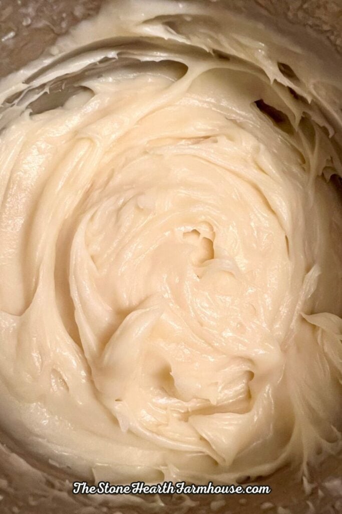 Creamy homemade cream cheese frosting prepared for cinnamon rolls