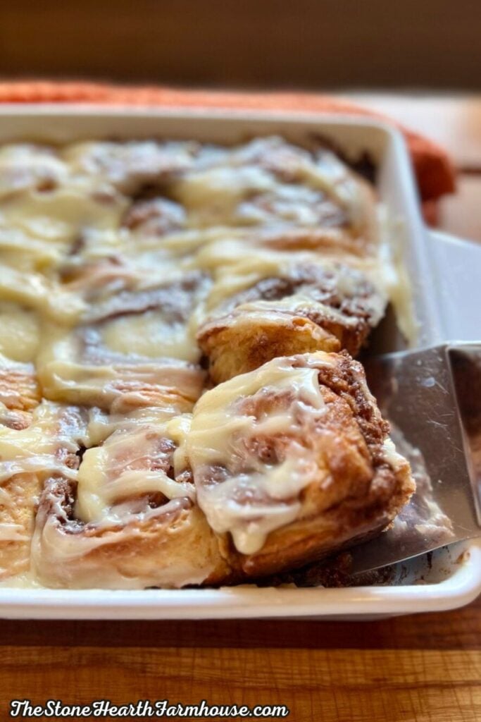 Soft baked sourdough cinnamon rolls covered with cream cheese frosting