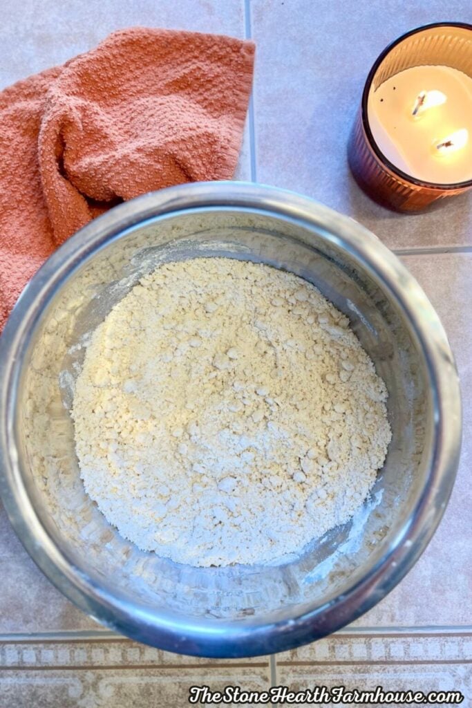 Dry ingredients for homemade sourdough cinnamon roll dough in a mixing bowl