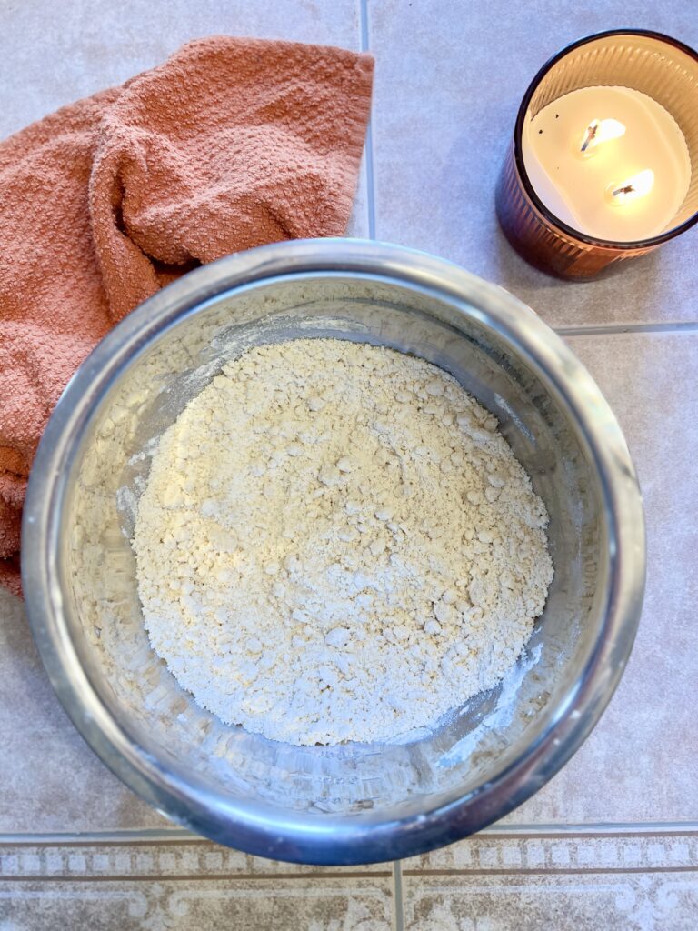 Flour mixture in a glass bowl for easy overnight sourdough cinnamon rolls, ready to be combined with wet ingredients.