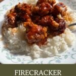 Firecracker rabbit recipe served over white rice, featuring crispy rabbit pieces coated in a glossy spicy sauce.