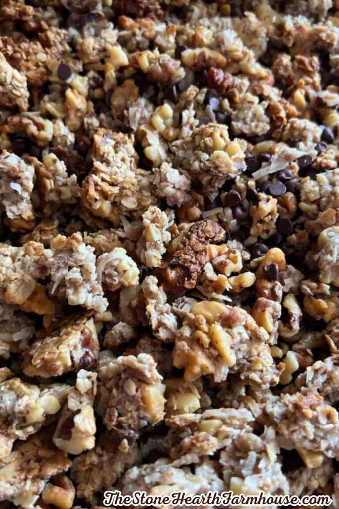 Close-up of crunchy homemade granola clusters with oats, nuts, and chocolate chips showing the toasted texture