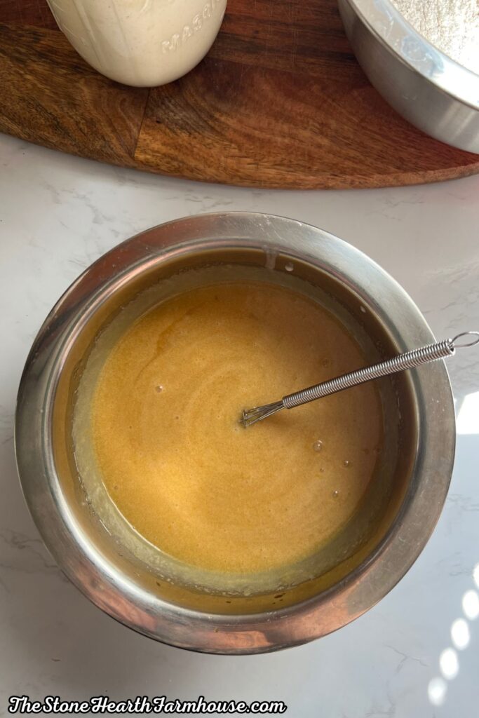 Wet banana bread ingredients combined in a mixing bowl