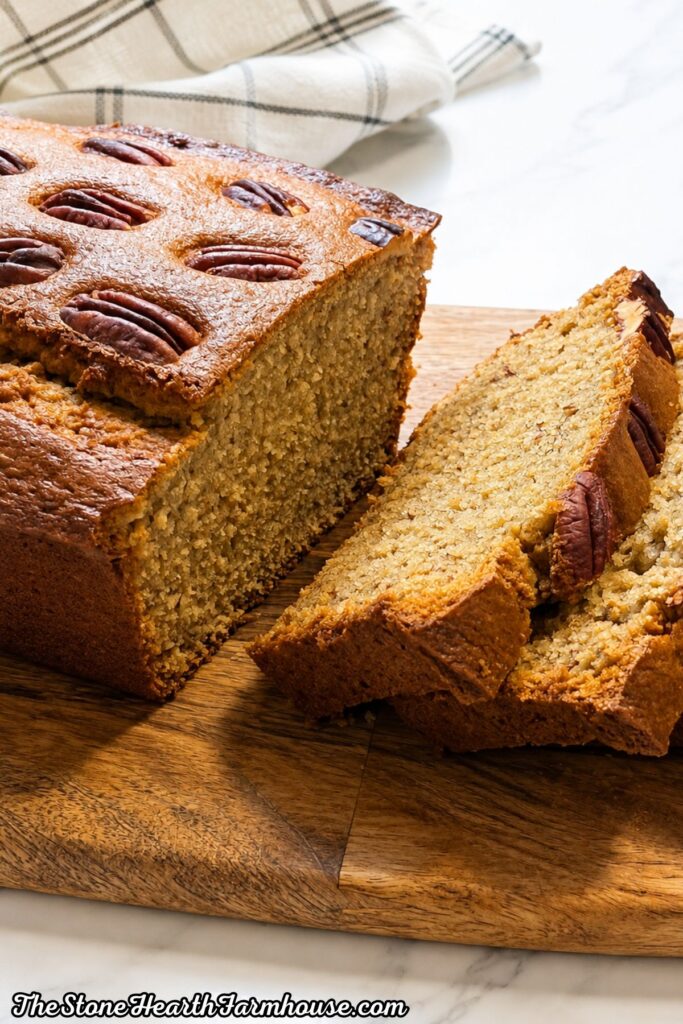 Close-up of moist banana bread slices showing the tender crumb and pecans