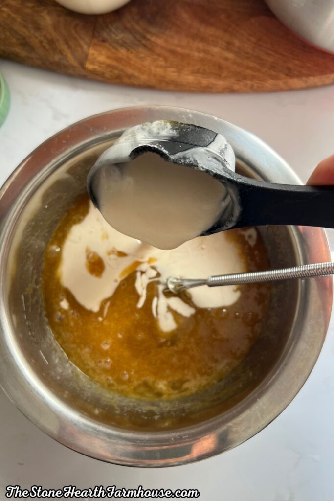 Wet banana bread ingredients combined in a mixing bowl with adding sourdough discard and vanilla. 