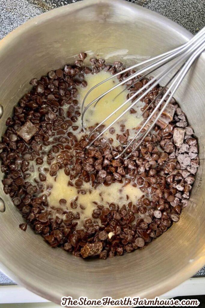 Chocolate chips and butter melting together in a saucepan for brownies