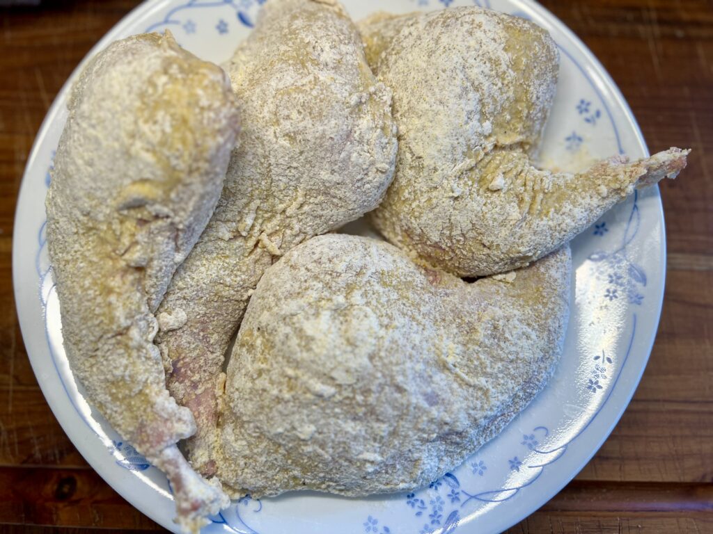 Rabbit Thighs covered in the cornmeal four mixture ready to fry.