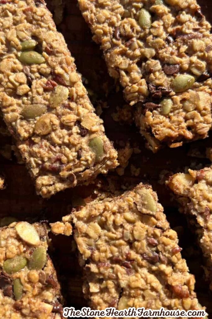Freshly baked oat granola bars filled with chocolate chips, pumpkin seeds, and pecans