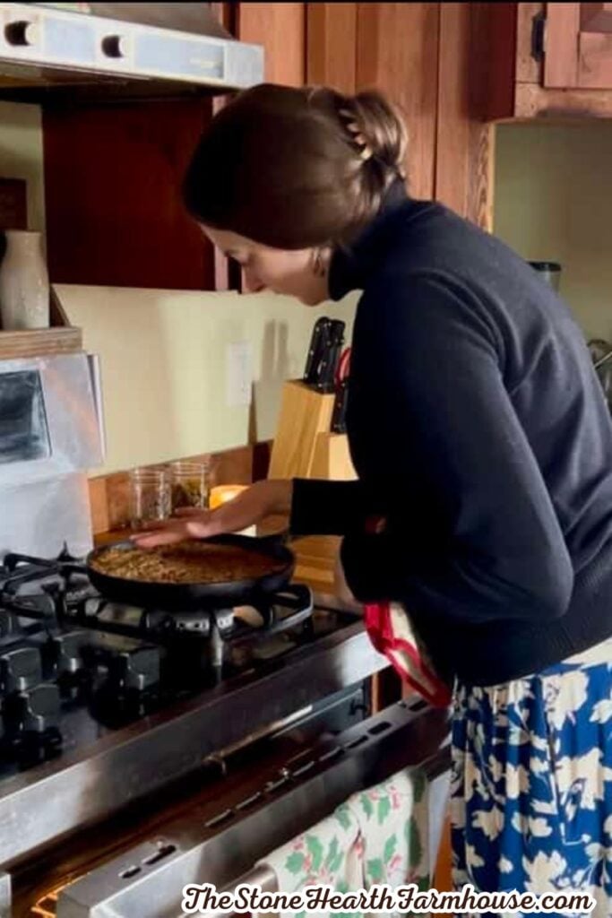 Homemade oat bars being pressed into a baking pan with a spatula