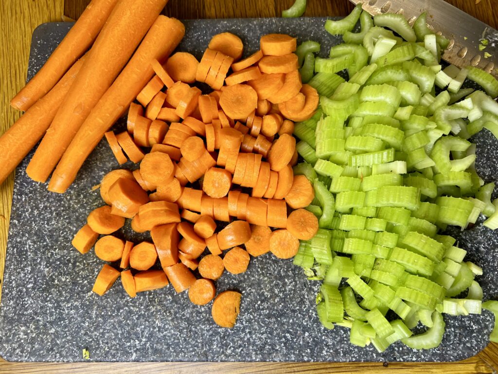 carrots and celery diced up on a cutting board.