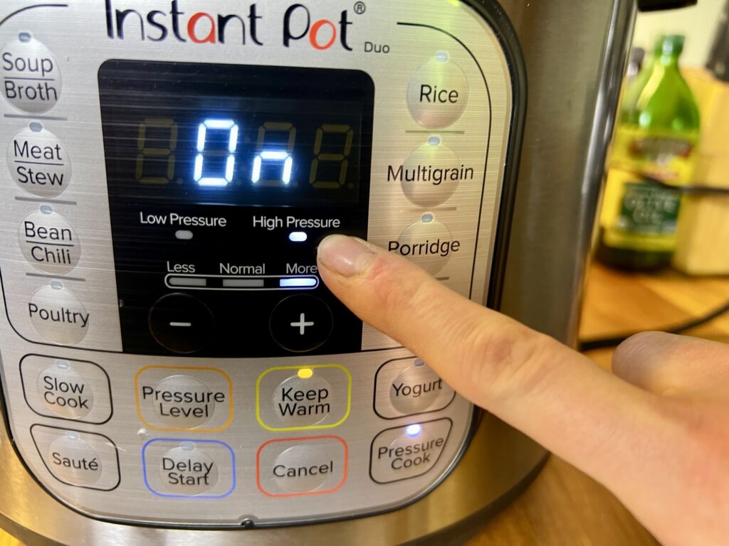 instant pot / pressure cooker showing which buttons to press to pressure cook the stew.