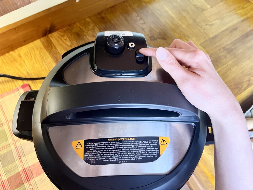 A hand sealing valve on an Instant Pot to build pressure for cooking.