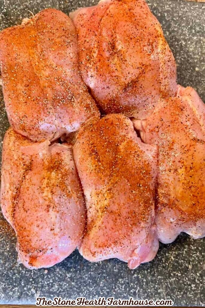 Seasoned rabbit pieces arranged on a countertop ready to be cooked for a creamy pasta dish