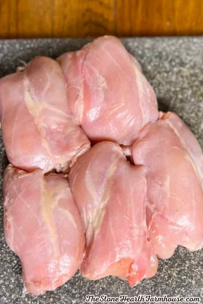 Raw rabbit pieces prepared for seasoning and cooking in this easy rabbit dinner recipe