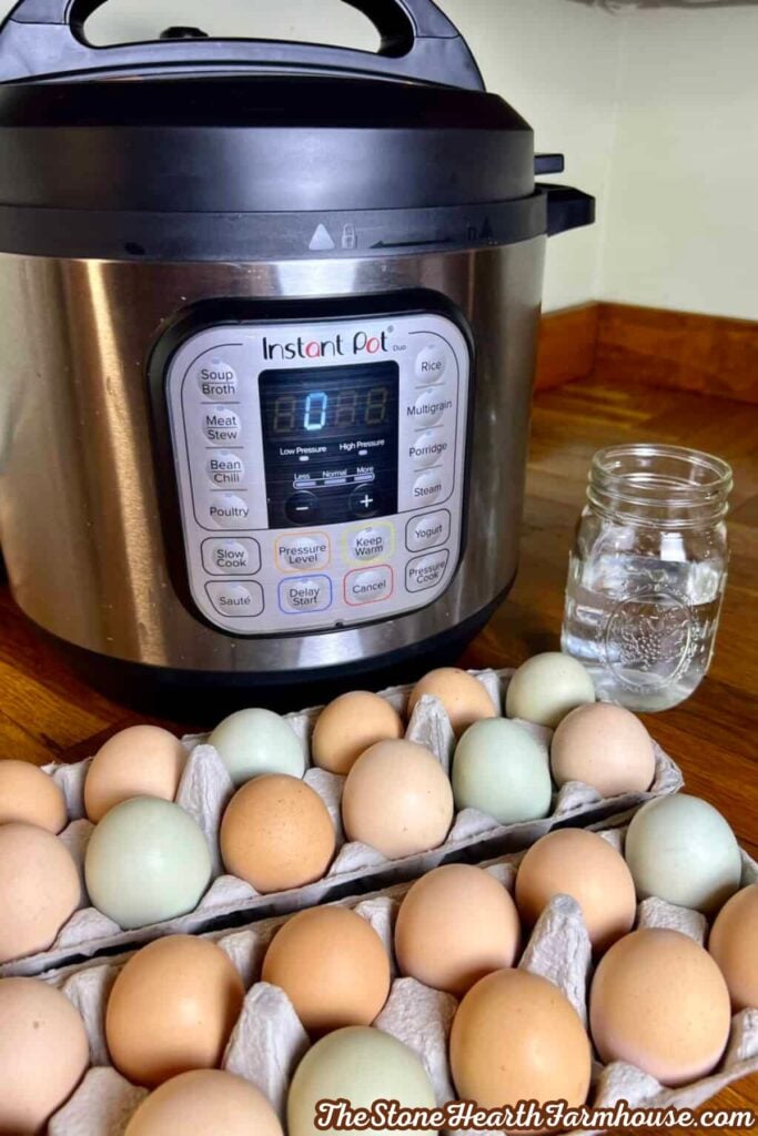 Fresh eggs arranged in cartons beside an Instant Pot and a glass jar of water, ready to make Instant Pot hard boiled eggs.