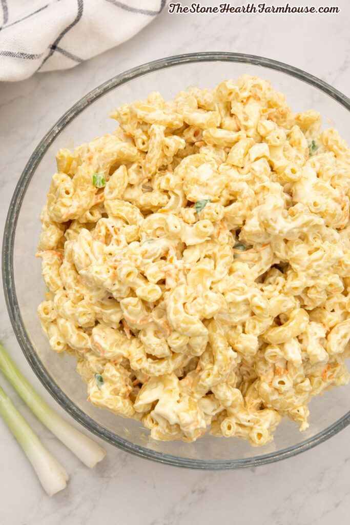 Creamy Hawaiian macaroni salad with tender pasta, shredded carrots, green onions, and a rich mayonnaise dressing