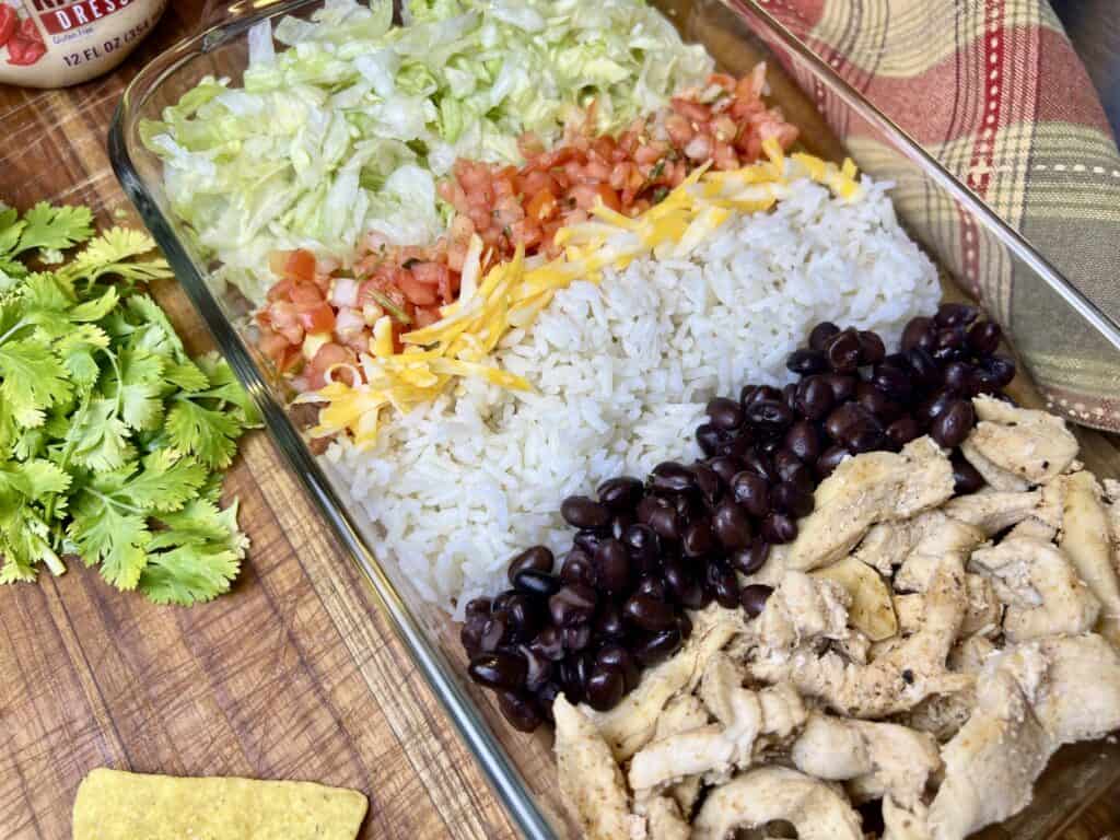 southwest salad on display in a glass container showing the different ingredients.