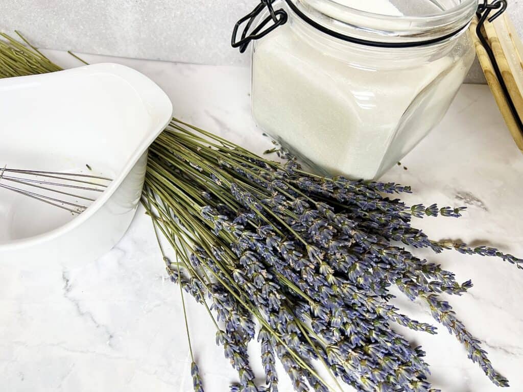 Lavender flowers and a jar of lavender syrup.