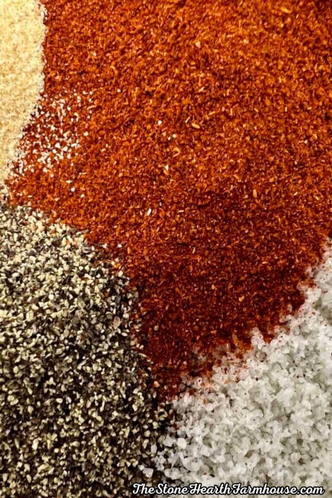 Seasonings including paprika, salt, and herbs prepared for crispy buttermilk fried chicken