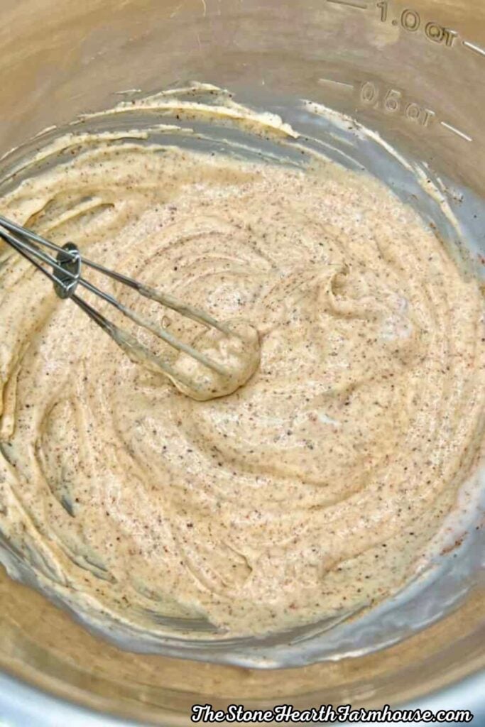Creamy seasoned sauce mixture for crispy fried chicken sandwiches in a glass mixing bowl