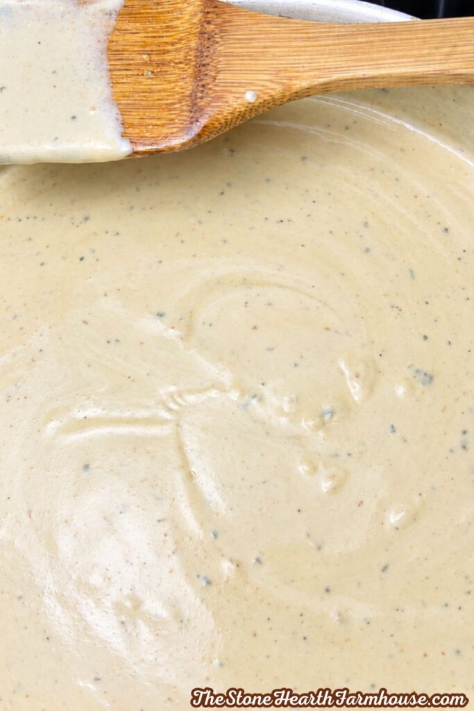 Close-up of creamy homemade chicken sauce with black pepper and seasonings