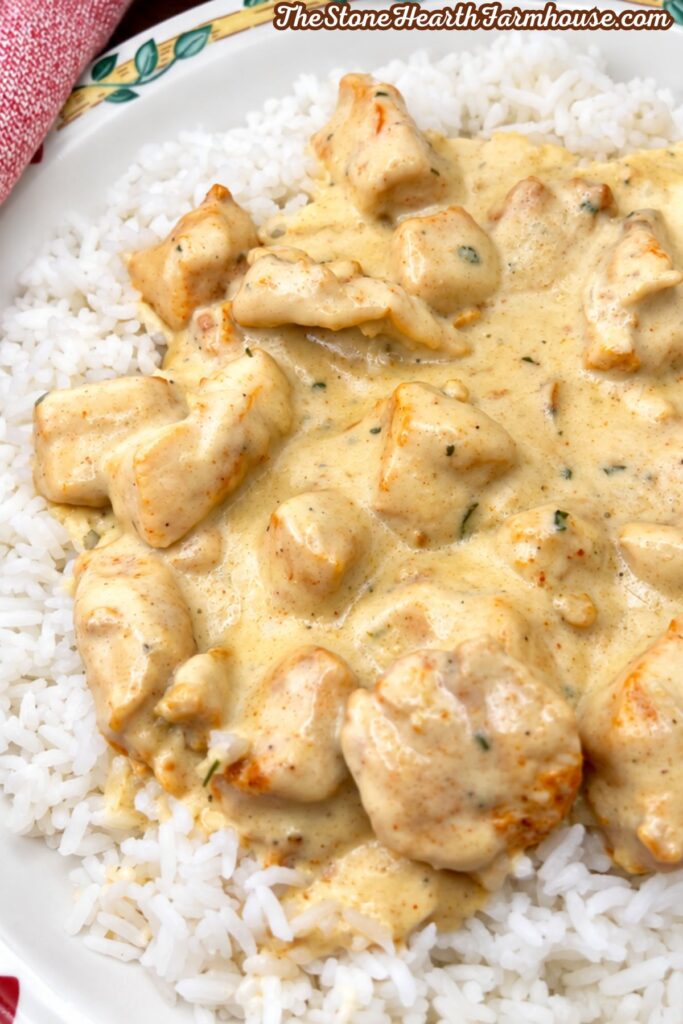 Creamy smothered chicken served over white rice for an easy dinner