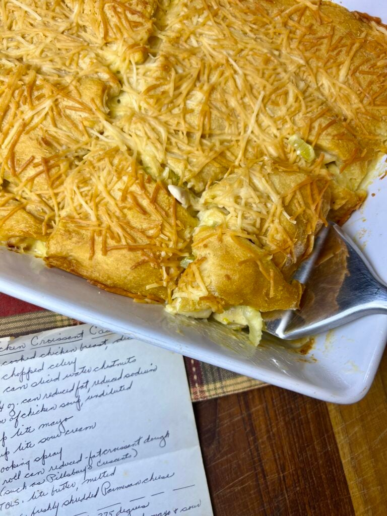Chicken crescent casserole being served alongside the recipe card to show where the recipe originated from.