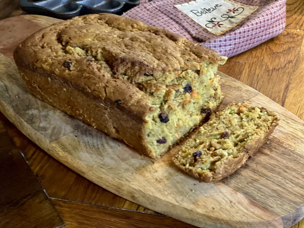 Cooled and sliced bread, ready to be enjoyed sitting on a wooden cutting board. 