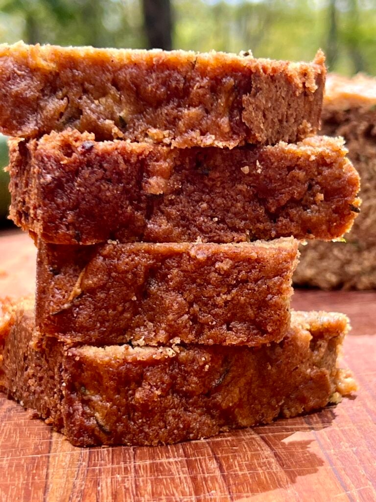 Moist sliced zucchini bread stacked on top of each other. 