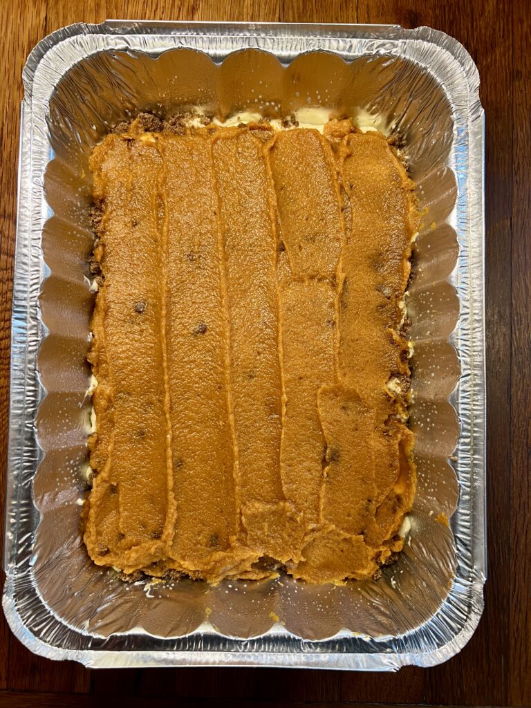 next add the pumpkin filling on top of the streusel. This makes the best cozy fall recipe for kids to help make. 
