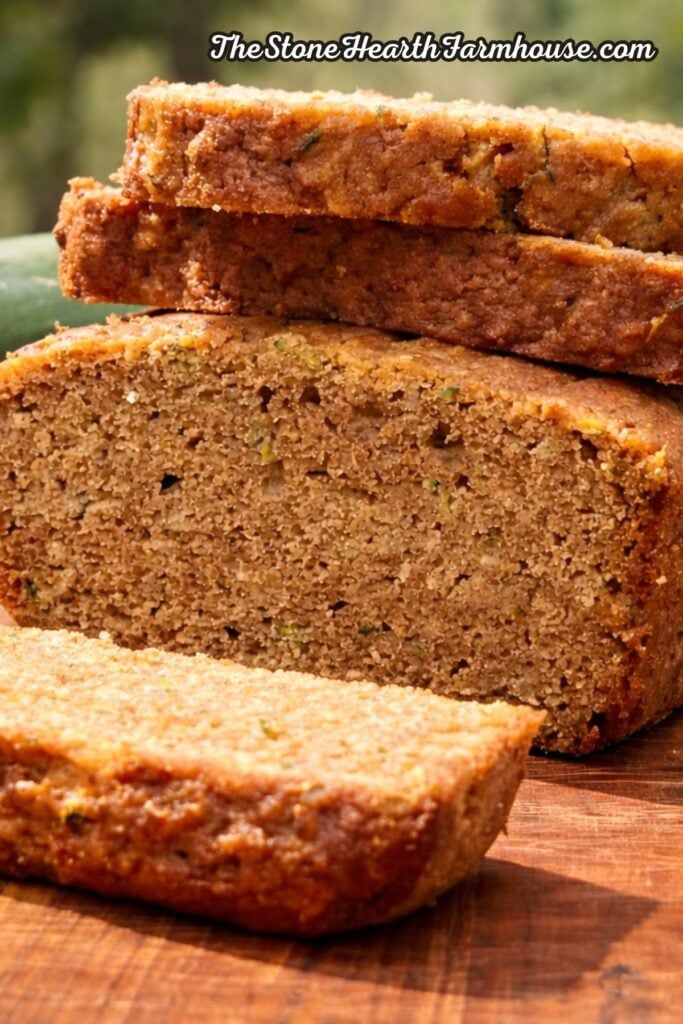 Sliced fresh milled zucchini bread showing a moist, tender crumb made with whole grain flour and fresh garden zucchini.