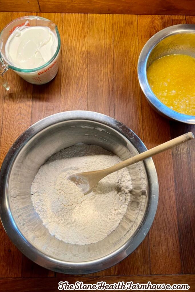 Flour mixture and melted butter arranged in bowls while preparing a cinnamon pumpkin cake.