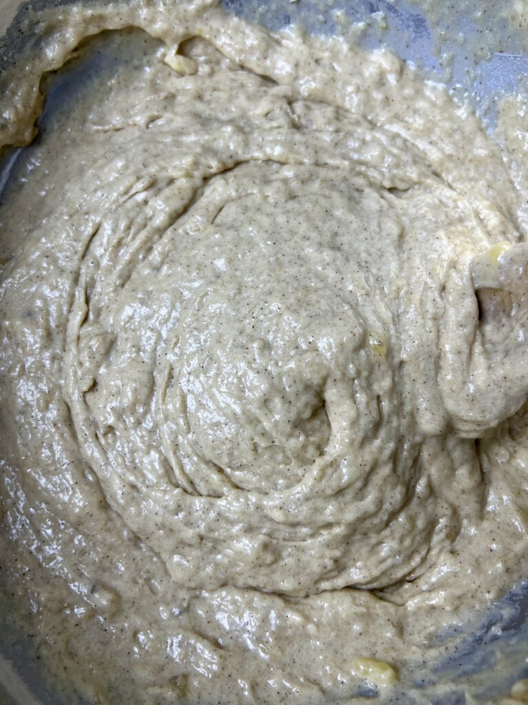 a close up of the wet ingredients for sourdough banana muffins mixed up in a bowl. 