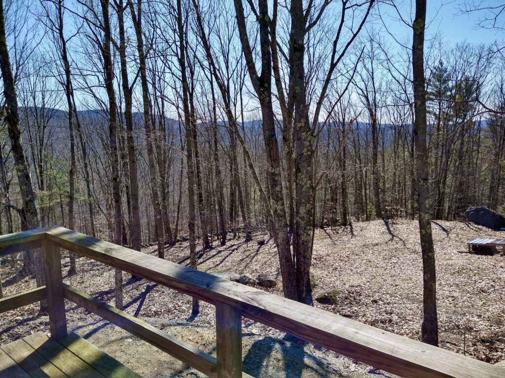 View from old deck showing wooded landscape and natural surroundings before DIY deck build