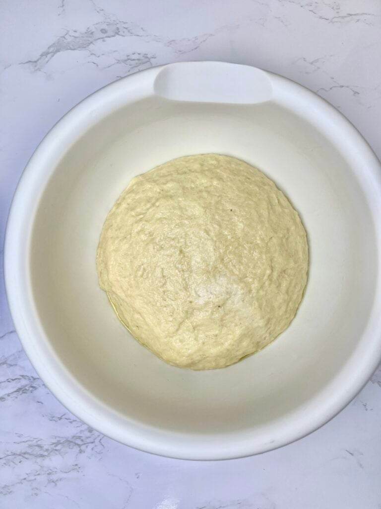 the next day, showing the dough after it sat in the fridge overnight and doubled in size. 