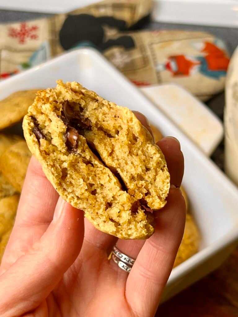 Soft and chewy brown butter sourdough chocolate chip cookie broken open to show tender crumb and melted chocolate