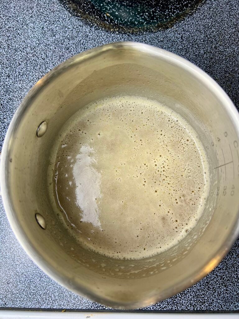 Unsalted butter in a saucepan before browning for brown butter sourdough chocolate chip cookies