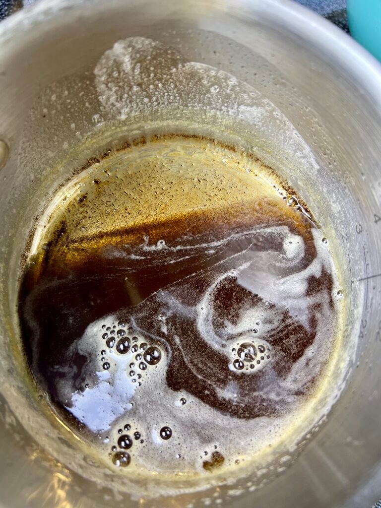 Brown butter melting in a saucepan for brown butter sourdough chocolate chip cookies