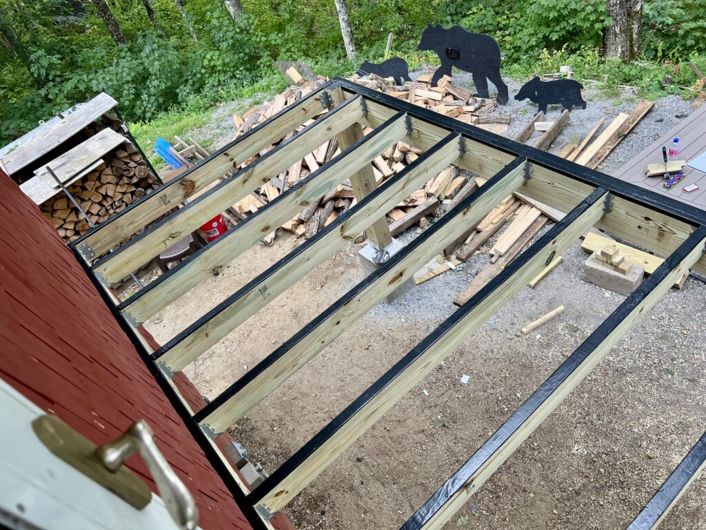 Overhead view of deck joists with black joist tape applied for moisture protection