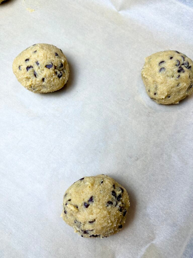 dough balls made with 2 tablespoons of dough, shaped and set on a baking pan with parchment paper. 