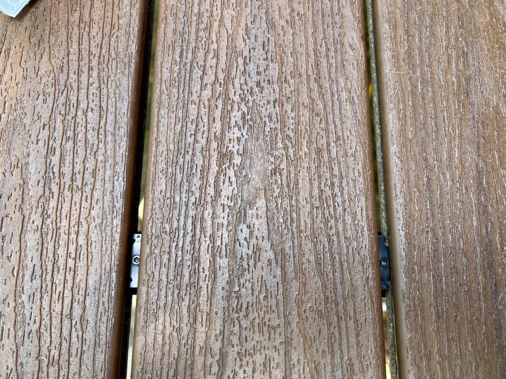 Close-up of Trex Hideaway hidden fasteners and screws on composite deck boards