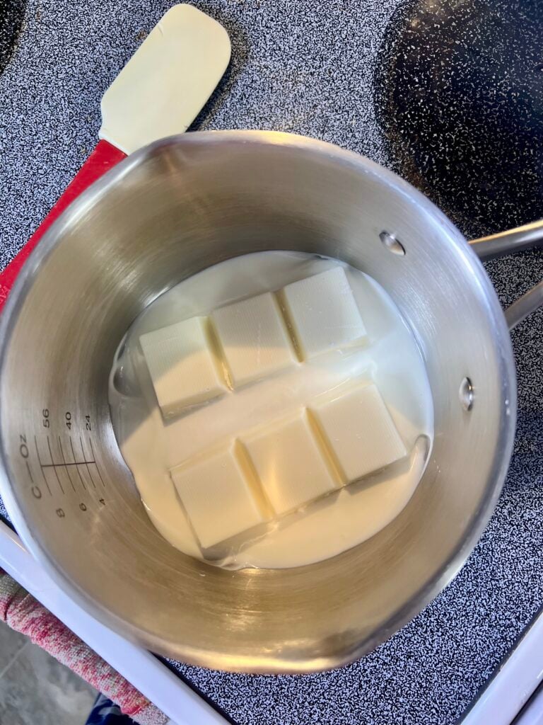 white chocolate melting in a pot on the stove. 