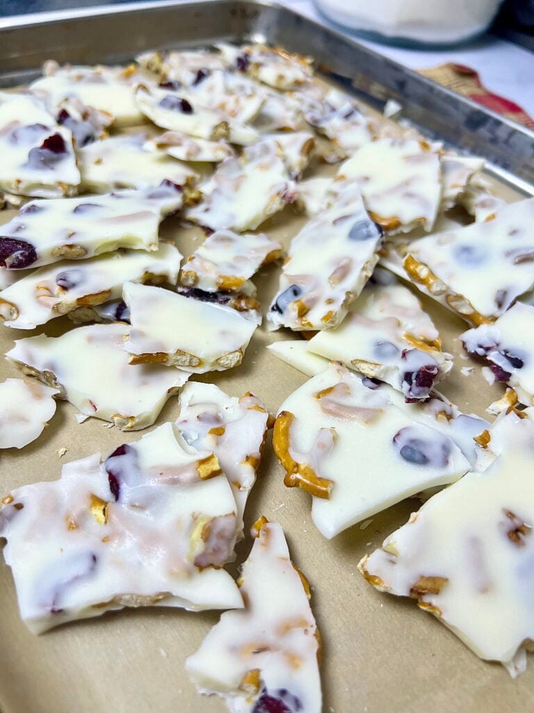 Close-up of White Chocolate Pretzel Bark pieces showing layers of white chocolate, pretzels, cranberries, and nuts