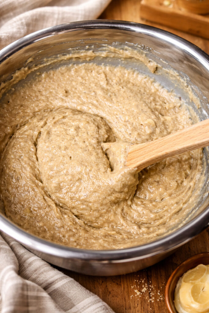 Banana bread batter mixed in a bowl using fresh milled flour, ripe bananas, and whole grain ingredients for a moist banana bread recipe