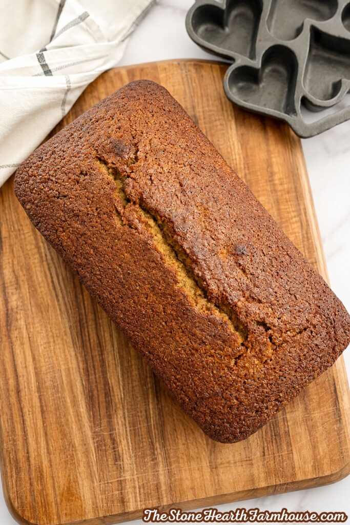 Homemade fresh milled banana bread made with soft white wheat on a wooden cutting board