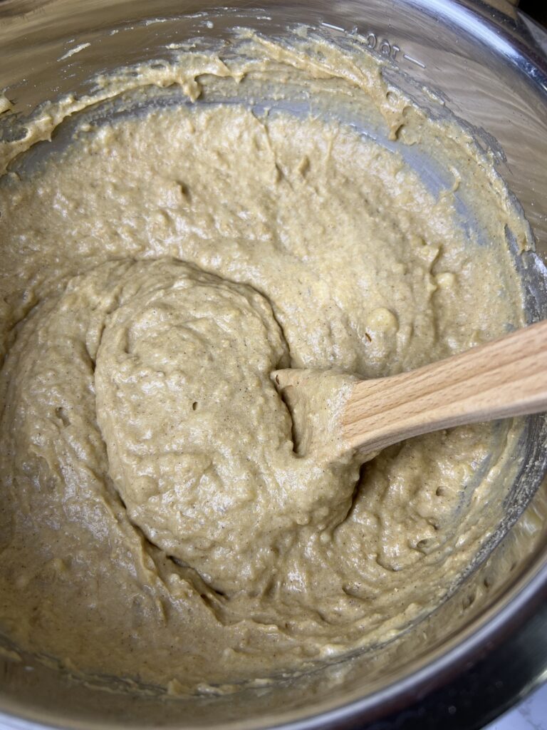 Banana bread batter mixed in a bowl using fresh milled flour, ripe bananas, and whole grain ingredients for a moist banana bread recipe