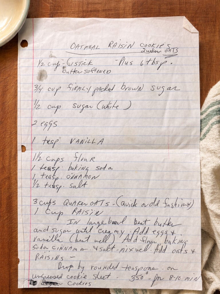 Handwritten oatmeal raisin cookie recipe on lined paper with ingredient measurements and baking instructions